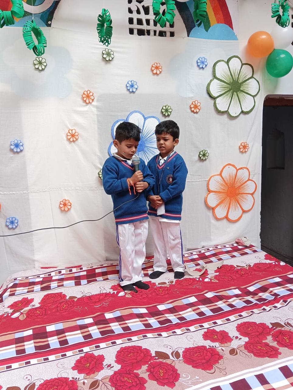 Two students reciting a poem on stage