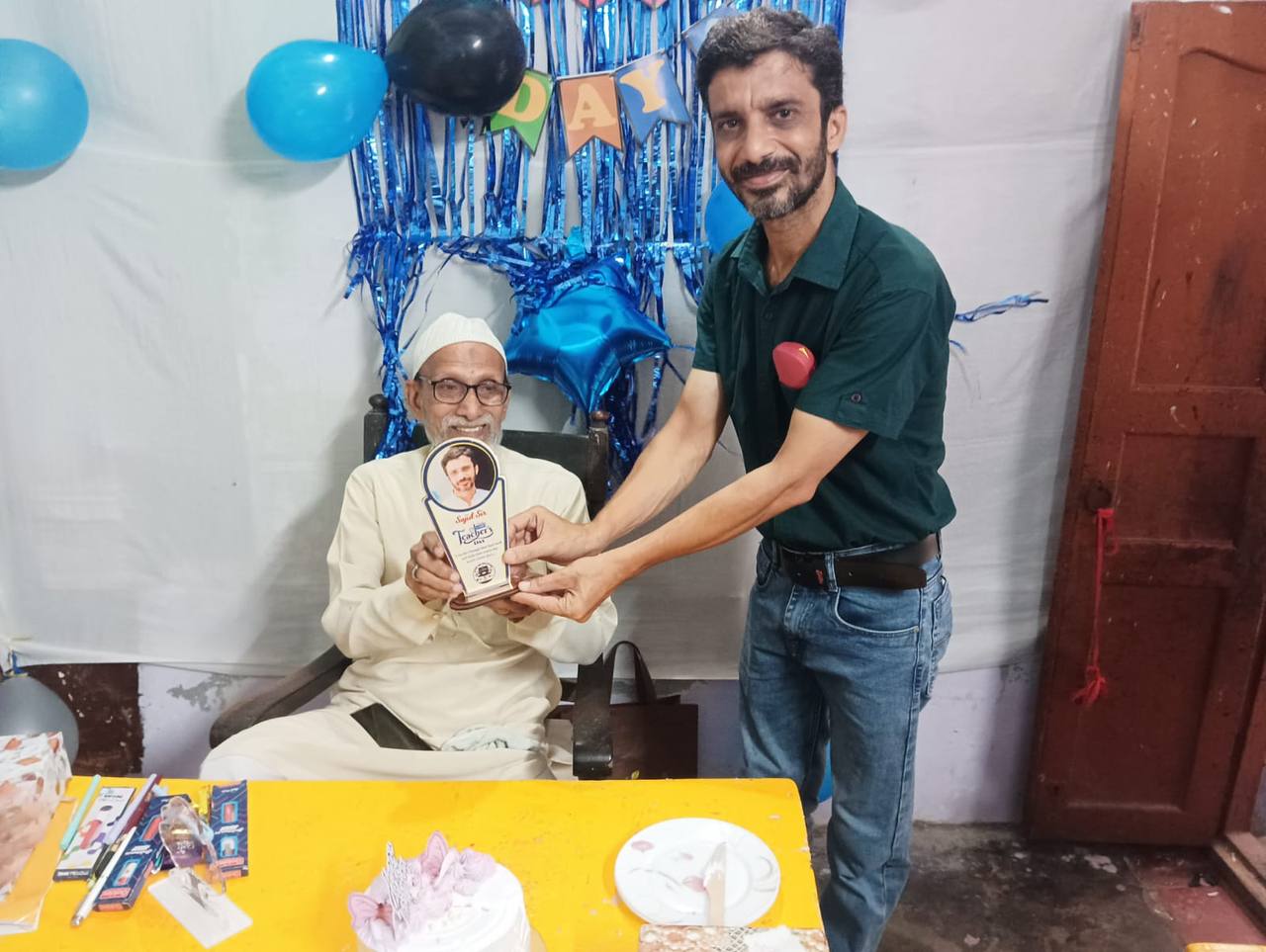 A trophy being presented to a senior teacher on Teachers' Day